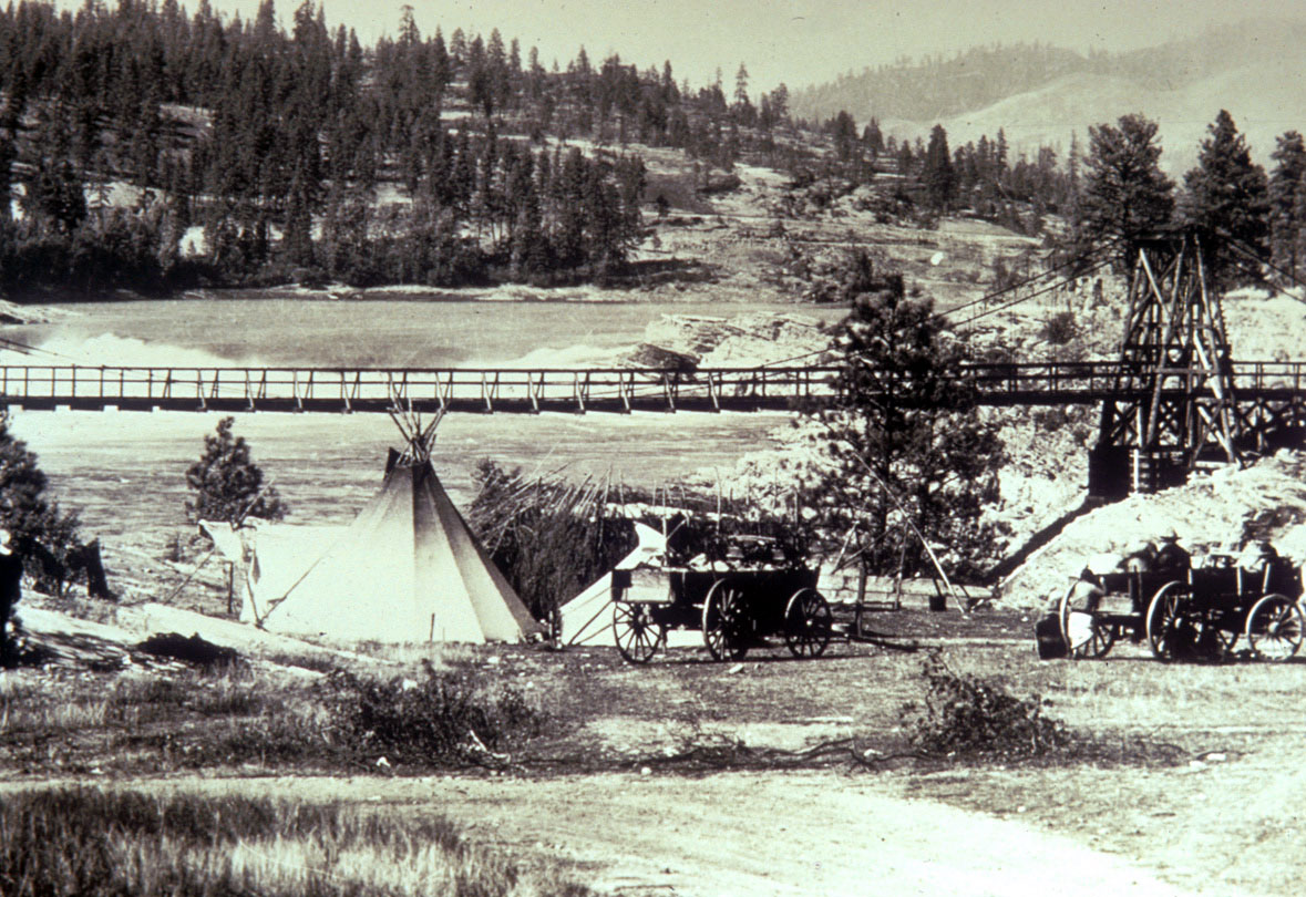 Historical photo of teepees and wagons along Lake Roosevelt shoreline.